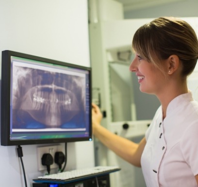 Dental team member looking at all digital dental x rays