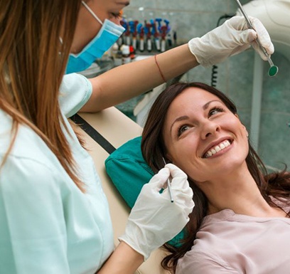 Patient smiling up at her dentist