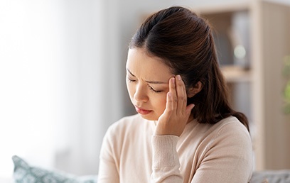 Woman struggling with TMD-related headache